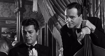 Movie still from “Some Like It Hot” (1959), directed by Billy Wilder – A black and white photo of two men in tuxedos; Close Up shot, Over the shoulder angle