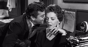 Movie still from “Some Like It Hot” (1959), directed by Billy Wilder – A man and a woman kissing in a black and white photo; Medium shot, Over the shoulder angle