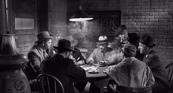 Movie still from “Some Like It Hot” (1959), directed by Billy Wilder – A black and white photo of men sitting at a table; Wide shot, High angle