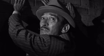 Movie still from “Some Like It Hot” (1959), directed by Billy Wilder – An old man with a hat and a mustache; Close Up shot, Low angle