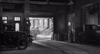 Movie still from “Some Like It Hot” (1959), directed by Billy Wilder – A black and white photo of two motorcycles parked in a garage; Extreme Wide shot, High angle