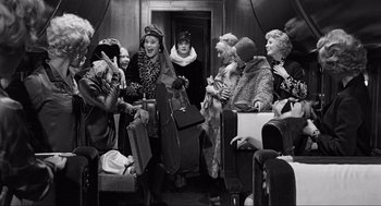 Movie still from “Some Like It Hot” (1959), directed by Billy Wilder – A group of women are standing in a room; Wide shot, High angle