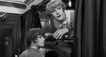 Movie still from “Some Like It Hot” (1959), directed by Billy Wilder – A man and a woman looking at each other in a room; Medium shot, Over the shoulder angle