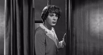 Movie still from “Some Like It Hot” (1959), directed by Billy Wilder – A woman standing in front of a curtain; Medium shot, Over the shoulder angle