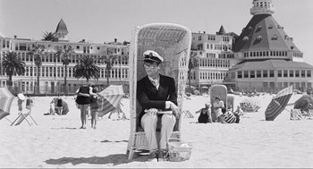 Movie still from “Some Like It Hot” (1959), directed by Billy Wilder – An old man sitting in a chair on the beach; Wide shot, High angle