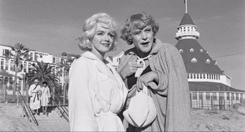 Movie still from “Some Like It Hot” (1959), directed by Billy Wilder – A couple of women standing next to each other on a pier; Medium shot, Low angle