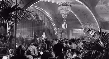 Movie still from “Some Like It Hot” (1959), directed by Billy Wilder – A large group of people are gathered together in a ballroom; Extreme Wide shot, High angle