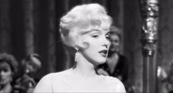 Movie still from “Some Like It Hot” (1959), directed by Billy Wilder – A black - and - white photo of a woman in a white dress; Close Up shot, Over the shoulder angle