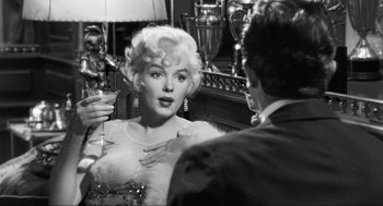 Movie still from “Some Like It Hot” (1959), directed by Billy Wilder – A black - and - white photo of a woman in front of a mirror; Close Up shot, Over the shoulder angle
