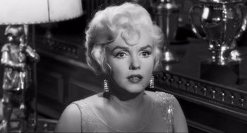 Movie still from “Some Like It Hot” (1959), directed by Billy Wilder – A black - and - white photo of a woman with blonde hair; Close Up shot, Over the shoulder angle