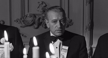 Movie still from “Some Like It Hot” (1959), directed by Billy Wilder – A man in a tuxedo sitting in front of candles; Close Up shot, Over the shoulder angle