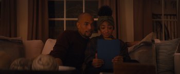 Movie still from “Something from Tiffany's” (2022), directed by Daryl Wein – A man and a woman are looking at a tablet; Medium shot, Over the shoulder angle