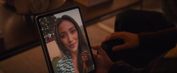 Movie still from “Something from Tiffany's” (2022), directed by Daryl Wein – A person taking a picture of a woman with long hair; Extreme Close Up shot, High angle