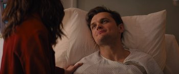 Movie still from “Something from Tiffany's” (2022), directed by Daryl Wein – A man laying in a hospital bed looking up at a woman; Close Up shot, Over the shoulder angle