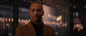 Movie still from “Something from Tiffany's” (2022), directed by Daryl Wein – A person wearing a suit and smiling; Close Up shot, Low angle