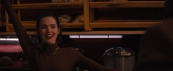 Movie still from “Something from Tiffany's” (2022), directed by Daryl Wein – A woman standing in a kitchen next to a pot; Medium shot, Over the shoulder angle