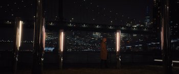 Movie still from “Something from Tiffany's” (2022), directed by Daryl Wein – A man standing in front of a city at night; Extreme Wide shot, High angle