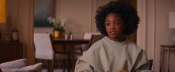Movie still from “Something from Tiffany's” (2022), directed by Daryl Wein – A young girl sitting at a table in front of a dining room table; Close Up shot, Over the shoulder angle