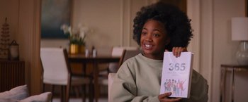 Movie still from “Something from Tiffany's” (2022), directed by Daryl Wein – A young woman holding a book in her hands; Close Up shot, Over the shoulder angle