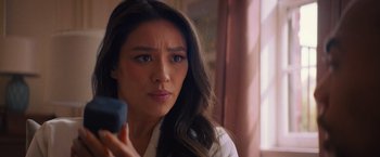 Movie still from “Something from Tiffany's” (2022), directed by Daryl Wein – A person holding a remote control; Close Up shot, Over the shoulder angle