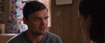 Movie still from “Something from Tiffany's” (2022), directed by Daryl Wein – A person sitting in front of a window; Close Up shot, Over the shoulder angle