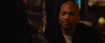 Movie still from “Something from Tiffany's” (2022), directed by Daryl Wein – A man with a bald head sitting at a table; Close Up shot, Over the shoulder angle