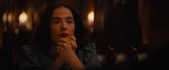 Movie still from “Something from Tiffany's” (2022), directed by Daryl Wein – A beautiful woman with red lipstick sitting in front of a candle; Close Up shot, Over the shoulder angle