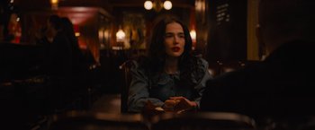 Movie still from “Something from Tiffany's” (2022), directed by Daryl Wein – A woman sitting at a table in front of a mirror; Medium shot, Over the shoulder angle