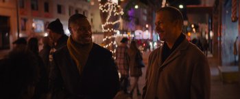 Movie still from “Something from Tiffany's” (2022), directed by Daryl Wein – A couple of men standing next to each other on a sidewalk; Medium shot, Over the shoulder angle