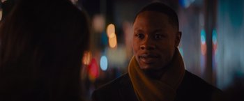 Movie still from “Something from Tiffany's” (2022), directed by Daryl Wein – A black man wearing a yellow scarf looking at the camera; Close Up shot, Over the shoulder angle