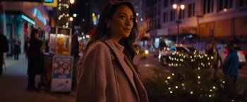 Movie still from “Something from Tiffany's” (2022), directed by Daryl Wein – A beautiful young lady standing on the side of a road; Medium shot, Over the shoulder angle