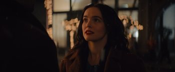 Movie still from “Something from Tiffany's” (2022), directed by Daryl Wein – A woman in a brown coat looking up at the sky; Close Up shot, Over the shoulder angle