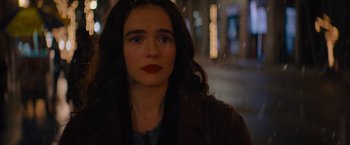 Movie still from “Something from Tiffany's” (2022), directed by Daryl Wein – A woman with long black hair wearing a brown jacket; Close Up shot, Over the shoulder angle