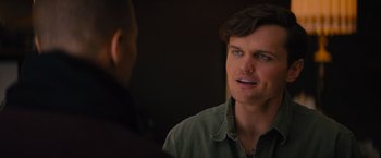Movie still from “Something from Tiffany's” (2022), directed by Daryl Wein – A man in a green shirt talking to another man in a green shirt; Close Up shot, Over the shoulder angle