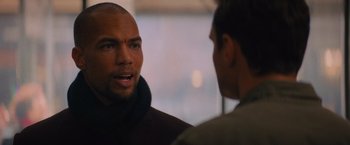 Movie still from “Something from Tiffany's” (2022), directed by Daryl Wein – Two men talking to each other in front of a window; Close Up shot, Over the shoulder angle