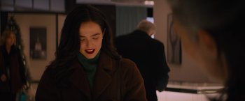 Movie still from “Something from Tiffany's” (2022), directed by Daryl Wein – A young woman with dark hair and red lipstick; Close Up shot, Over the shoulder angle
