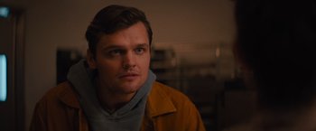 Movie still from “Something from Tiffany's” (2022), directed by Daryl Wein – A person wearing a yellow jacket; Close Up shot, Over the shoulder angle