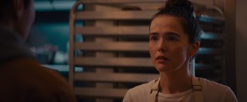 Movie still from “Something from Tiffany's” (2022), directed by Daryl Wein – A young woman is sitting in front of a wooden wall; Close Up shot, Over the shoulder angle