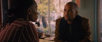 Movie still from “Something from Tiffany's” (2022), directed by Daryl Wein – A man and a woman sitting in front of each other at a table; Medium shot, Over the shoulder angle