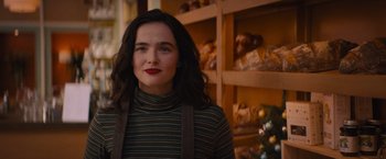 Movie still from “Something from Tiffany's” (2022), directed by Daryl Wein – A woman with long black hair wearing a striped sweater; Close Up shot, Over the shoulder angle