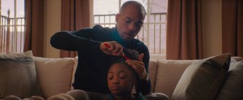 Movie still from “Something from Tiffany's” (2022), directed by Daryl Wein – A man is cutting the hair of a young girl; Medium shot, Over the shoulder angle