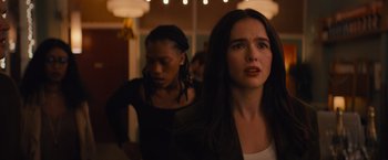 Movie still from “Something from Tiffany's” (2022), directed by Daryl Wein – Two women are standing in a room with lights in the background; Close Up shot, Over the shoulder angle
