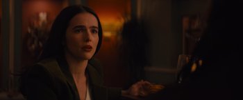 Movie still from “Something from Tiffany's” (2022), directed by Daryl Wein – A woman sitting in front of a window looking up; Close Up shot, Over the shoulder angle