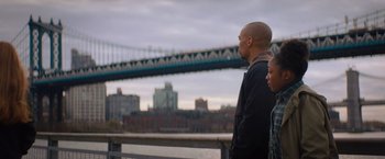 Movie still from “Something from Tiffany's” (2022), directed by Daryl Wein – A man and a woman looking out at a bridge; Medium shot, Low angle