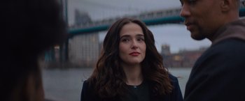 Movie still from “Something from Tiffany's” (2022), directed by Daryl Wein – A woman with long brown hair standing in front of a bridge; Close Up shot, Over the shoulder angle
