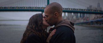 Movie still from “Something from Tiffany's” (2022), directed by Daryl Wein – A man and a woman kissing in front of a building; Close Up shot, Low angle