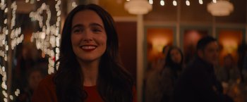 Movie still from “Something from Tiffany's” (2022), directed by Daryl Wein – A person with a smile on their face; Close Up shot, Over the shoulder angle