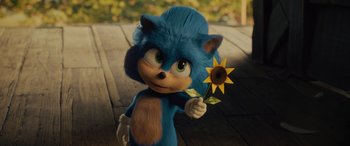 Movie still from “Sonic the Hedgehog” (2020), directed by Jeff Fowler – A character from sonic the hedgehog holding a sunflower; Medium shot, Over the shoulder angle