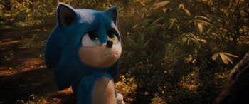 Movie still from “Sonic the Hedgehog” (2020), directed by Jeff Fowler – A toy sonic sitting in the middle of a forest; Close Up shot, Over the shoulder angle