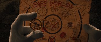 Movie still from “Sonic the Hedgehog” (2020), directed by Jeff Fowler – A hand is holding a wedding ring in front of a map; Extreme Close Up shot, Overhead angle